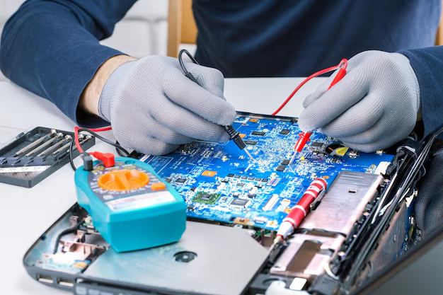 A circuit board being probed with a multimeter during fault diagnosis