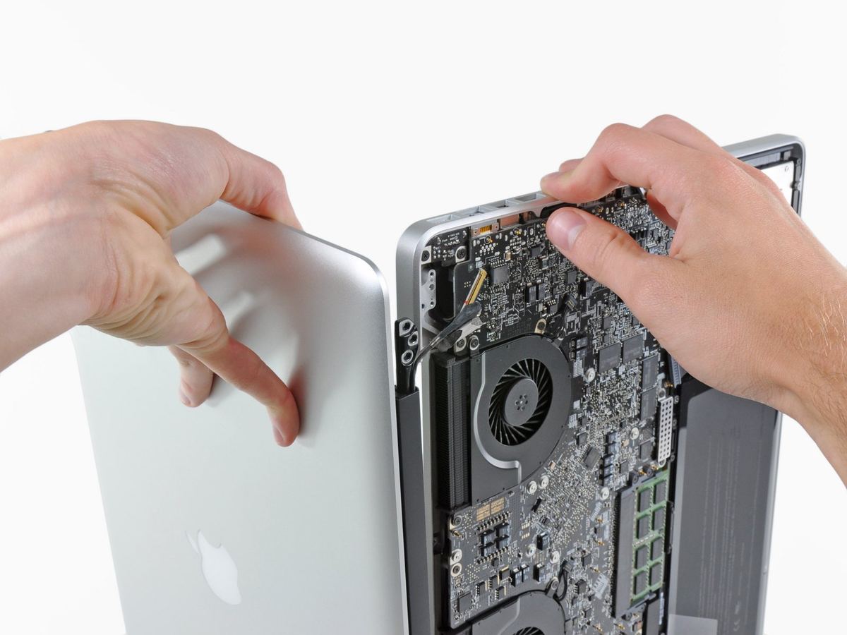 A MacBook Pro opened up with its cooling fans and logic board visible